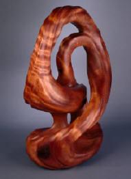 Finished redwood burl sculpture, entitled Infinity Rising, by Harry Pollitt.  Sweeping curves, large amounts of negative space and a lustrous finish are the key features of this piece.