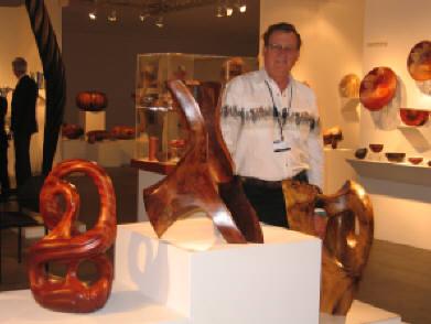 Harry Pollitt surrounded by three of his wood sculptures - Infinity Rise, Monument Mesa and Moab at at SOFA Chicago 2008 in the del Mano Gallery exhibit.