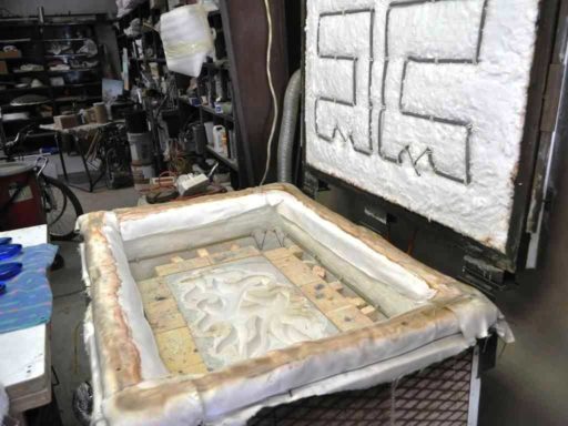 Plaster mold for Pollitt's glass wall sculpture placed in the kiln