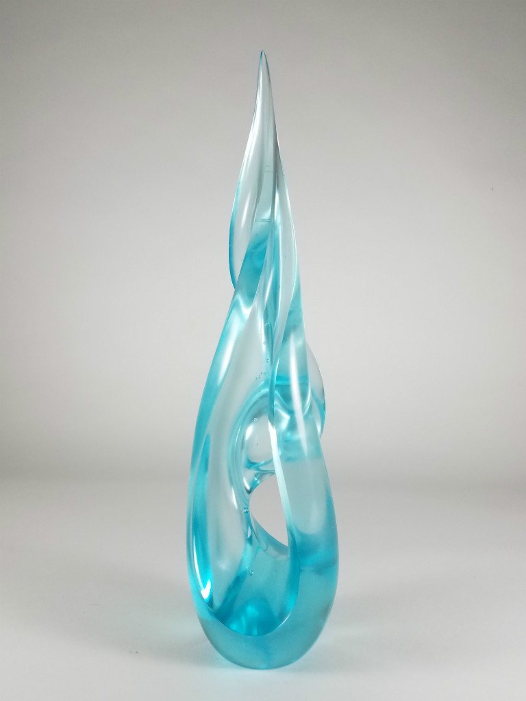 A luminous glass sculpture in pale copper blue by Harry Pollitt