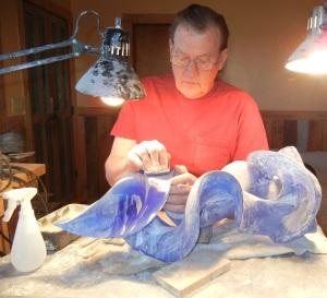 Sculptor, Harry Pollitt, sanding his glass sculpture (on Blue Tango, not Blue Shift) to remove tool marks left by grinding process and to smooth out the piece to a fine finish.