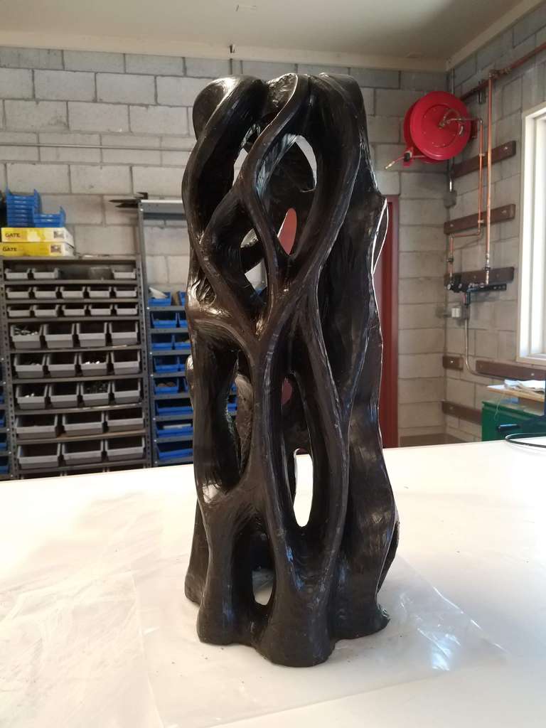 A roughed out, 24" high wax sculpture with twists, turns and undulations in the first-step of the glass sculpture process.
