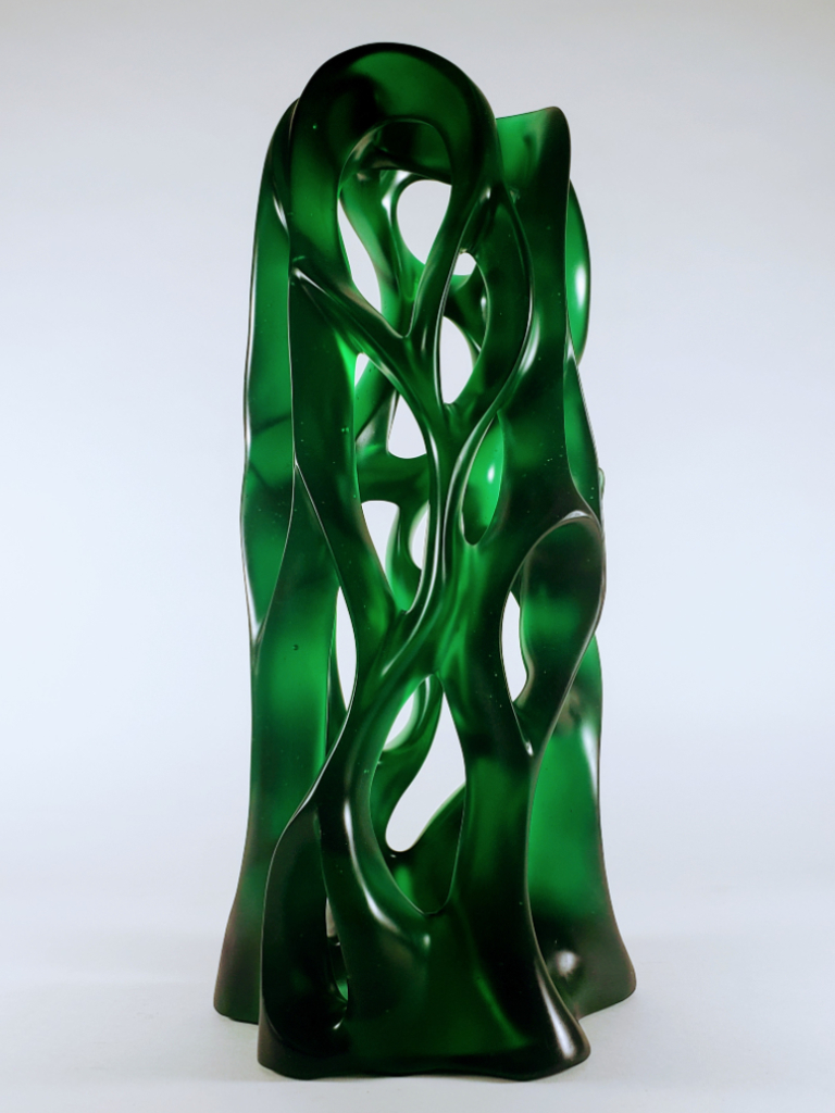 Gentle curves, peek-a-boo sweeps and negative space capture the dark and lighter shades of this emerald green cast glass sculpture by Harry Pollitt.