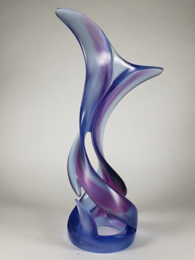 Kiln-casting cleared the way for a purple ribbon-like path through the pale cobalt blue, 1'-9" high glass sculpture by Harry Pollitt.